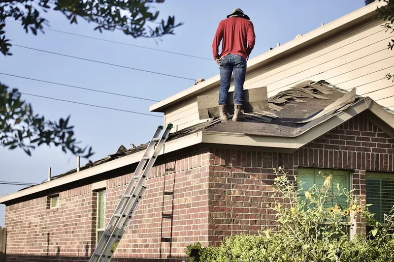 Professional roofer working on a residential roof in Westford